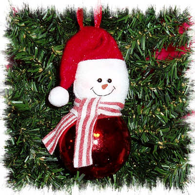 FELT SNOWMAN ATOP A CHRISTMAS ORNAMENT